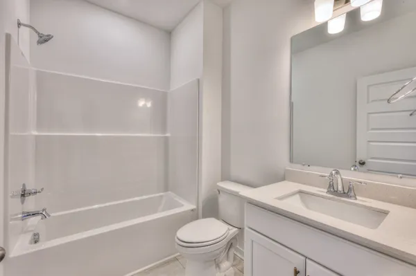 a large kitchen with stainless steel appliances granite countertop a sink a stove and a refrigerator