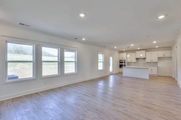 a large kitchen with a large window and stainless steel appliances