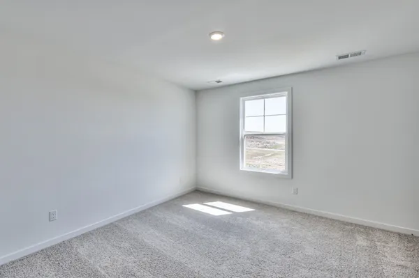 an empty room with closet area