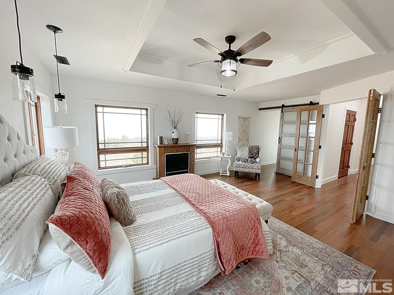 4280 Rocky Road Reno, NV 89521 - Photo 11 of 40 a spacious bedroom with a large bed and a chandelier