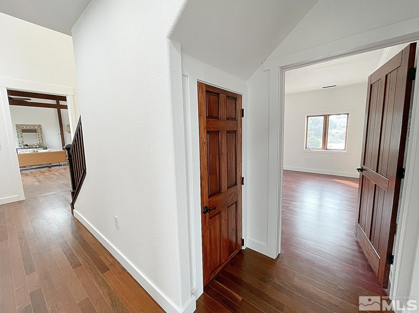 4280 Rocky Road Reno, NV 89521 - Photo 23 of 40 a view of a hallway with wooden floor and stairs