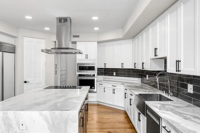 a kitchen with a stove a sink and a refrigerator