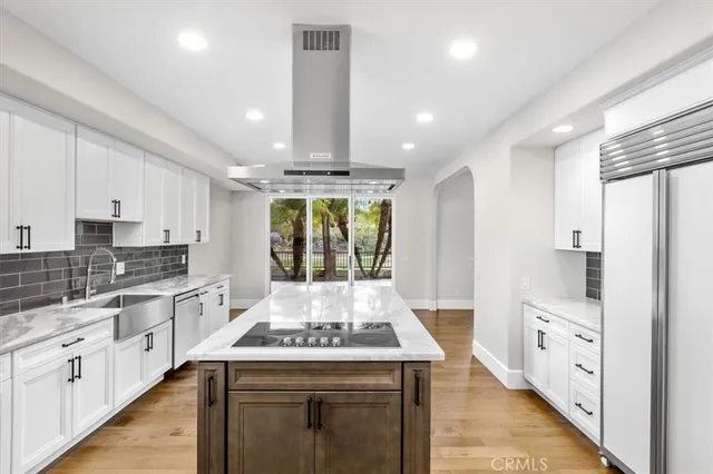 a kitchen with a sink stove and cabinets