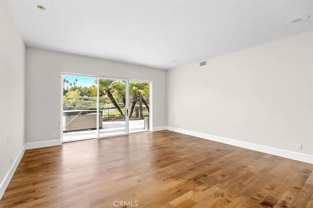 a view of an empty room and wooden floor