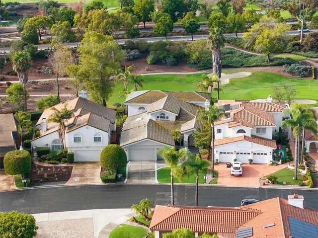 an aerial view of a house with garden space and street view