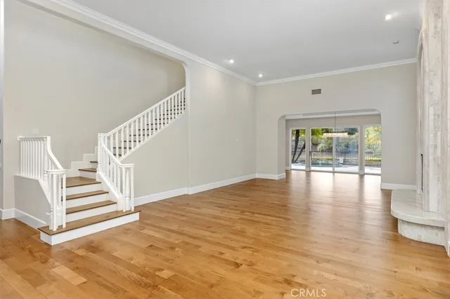 a view of a room with wooden floor and white walls