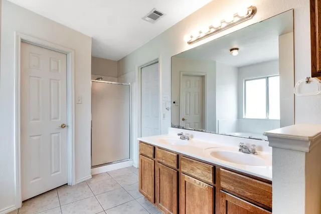 a bathroom with a double vanity sink mirror and