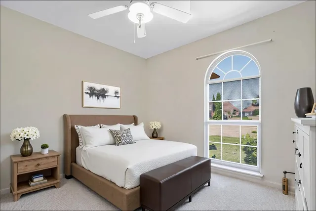 an empty room with a window and a fan