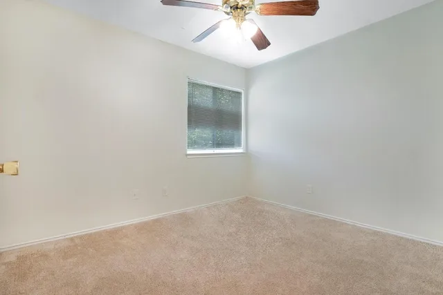 a bedroom with bed and a window