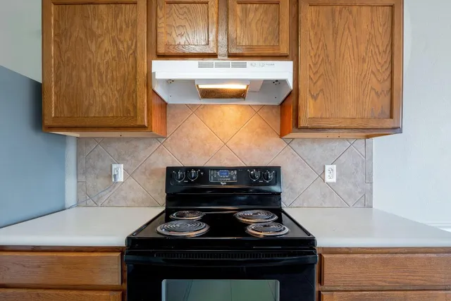 a stove top oven sitting inside of a kitchen