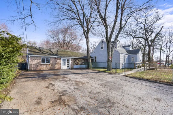 a view of a house with a yard covered in snow