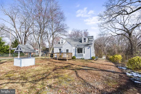 a view of a house with a yard covered in snow