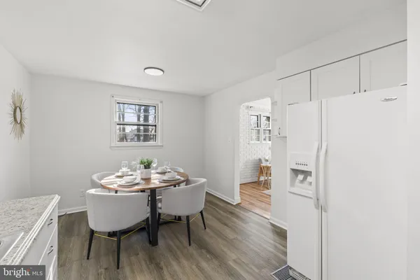 a room with a couch and washer dryer