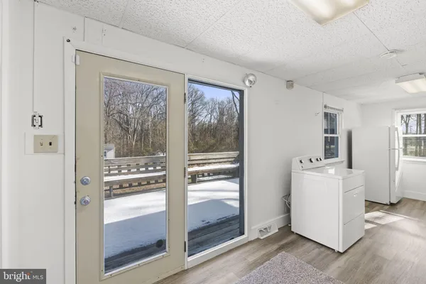 a white bath tub sitting next to a white sink and vanity