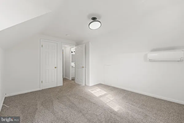 a bedroom with a large bed and a potted plant