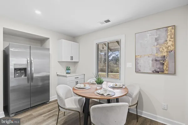 a view of a house with a yard covered in snow