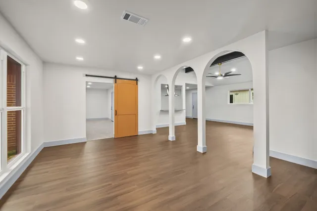 a view of empty room with wooden floor