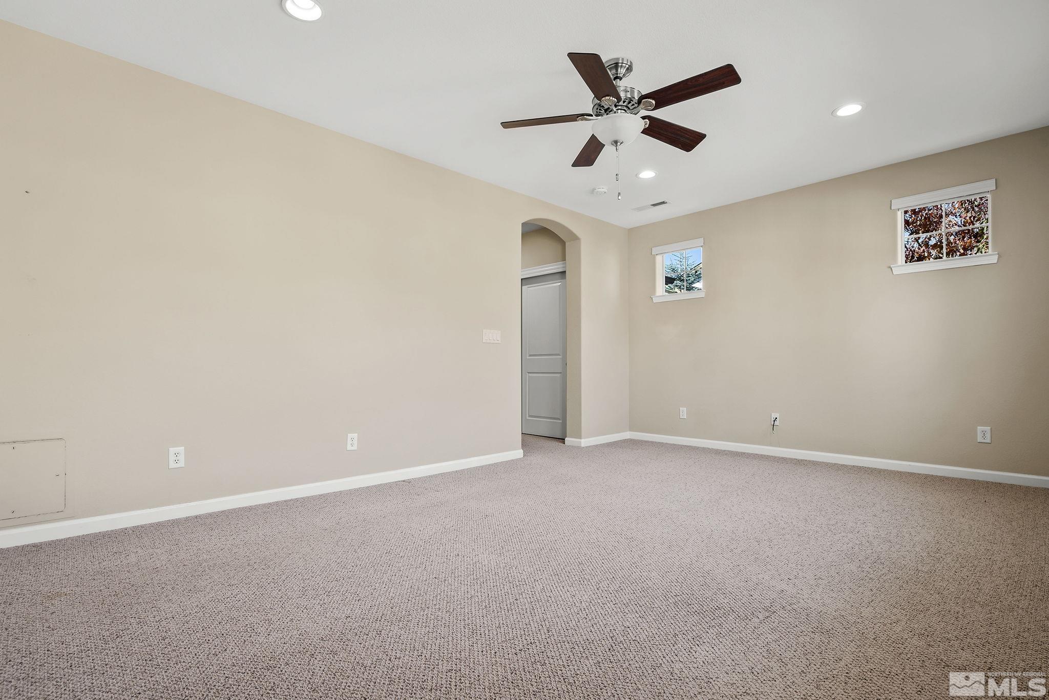 7688 Stone Bluff Way Reno, NV 89523 - Photo 14 of 26 an empty room with a ceiling fan and a window