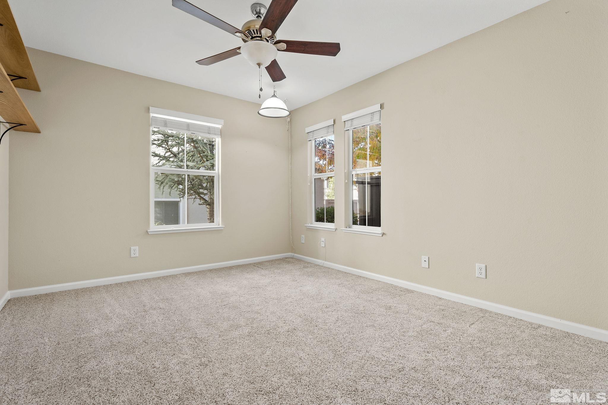 7688 Stone Bluff Way Reno, NV 89523 - Photo 17 of 26 an empty room with windows and fan