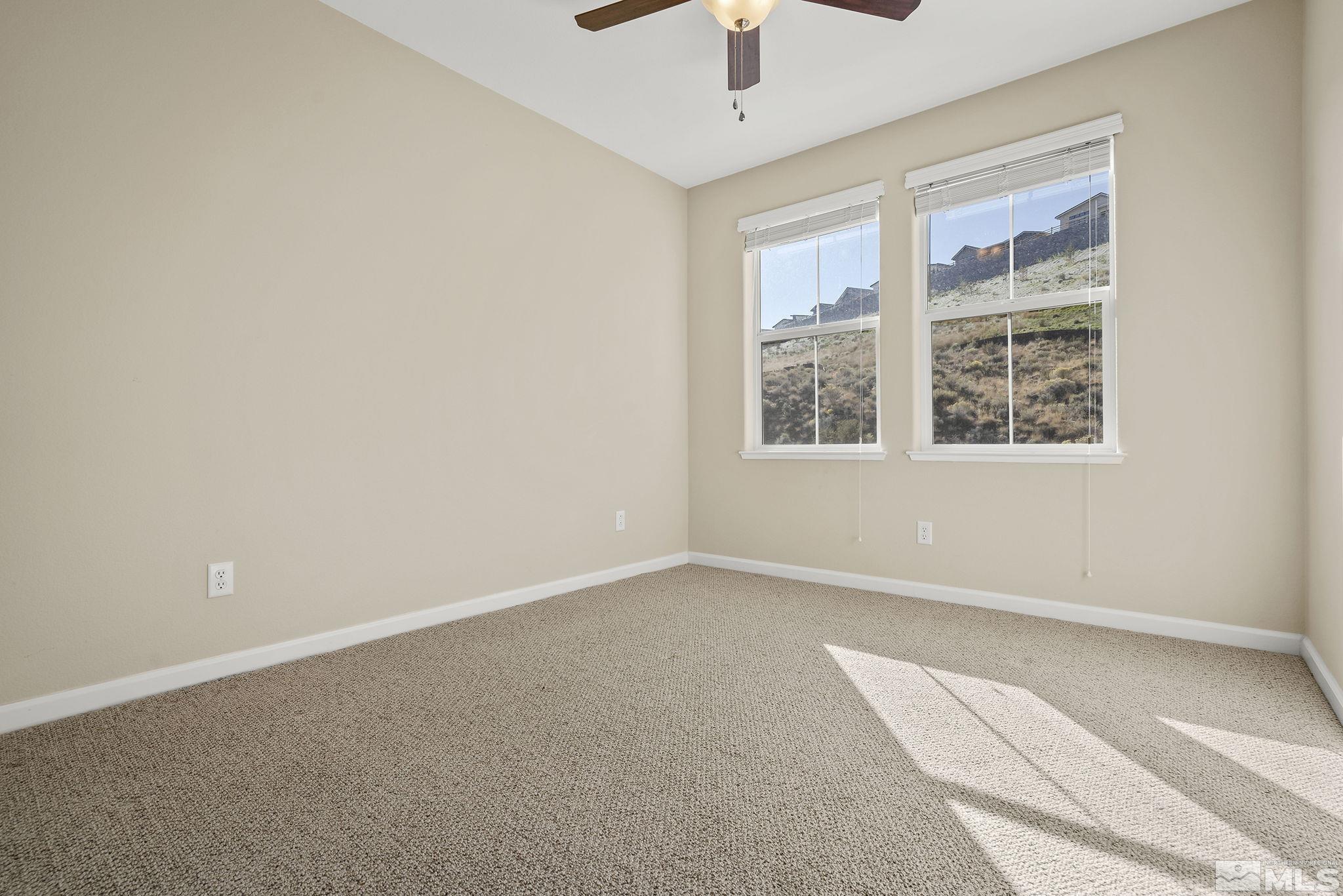 7688 Stone Bluff Way Reno, NV 89523 - Photo 19 of 26 an empty room with a window and a ceiling fan