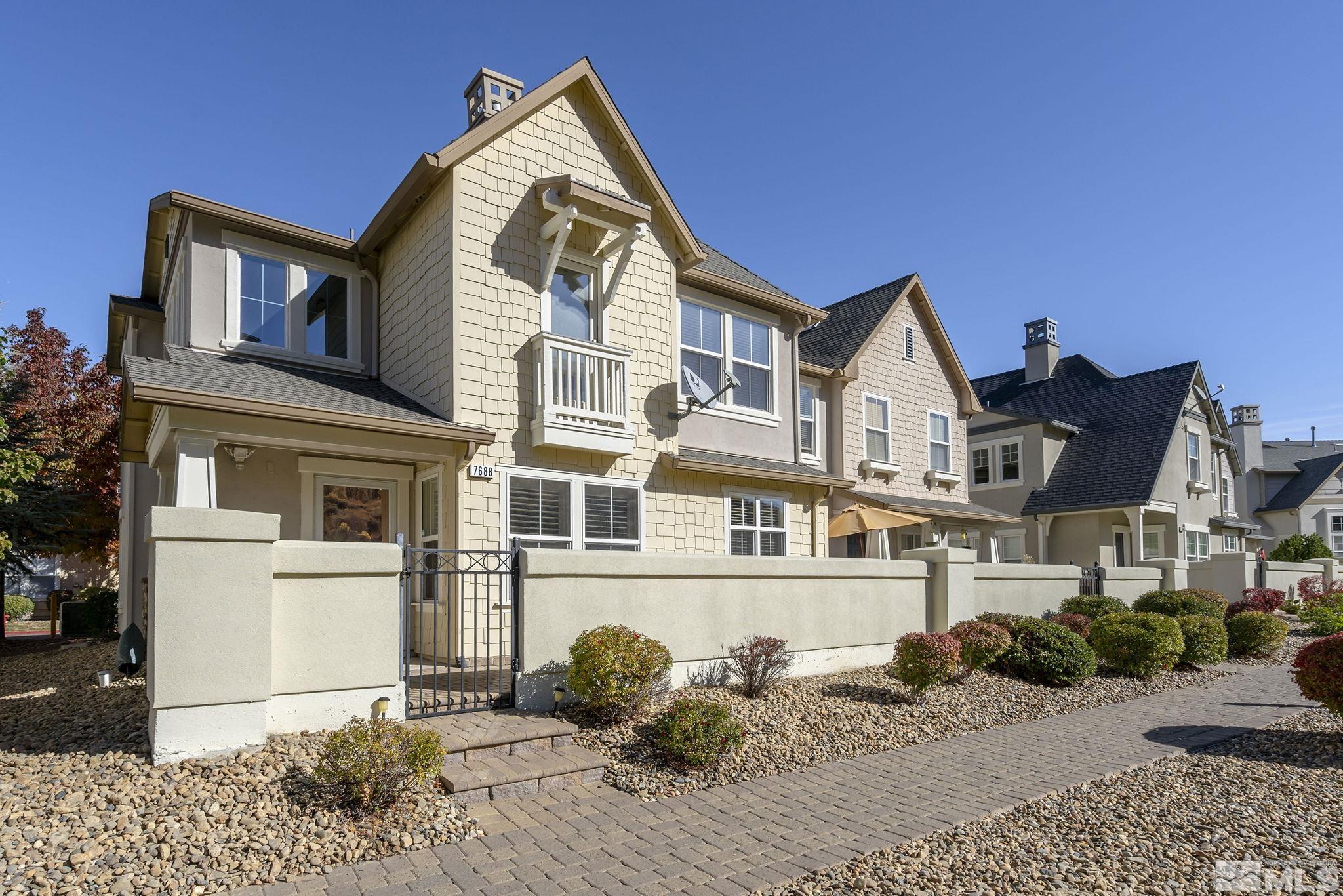 7688 Stone Bluff Way Reno, NV 89523 - Photo 2 of 26 a front view of a house with a yard