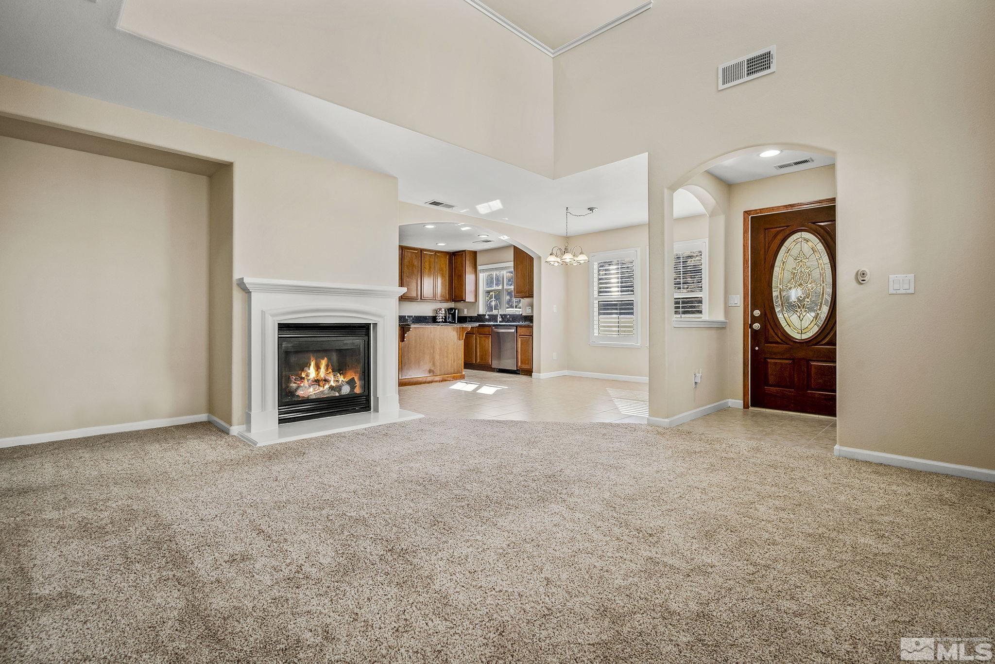 7688 Stone Bluff Way Reno, NV 89523 - Photo 5 of 26 an empty room with a fireplace and mirror