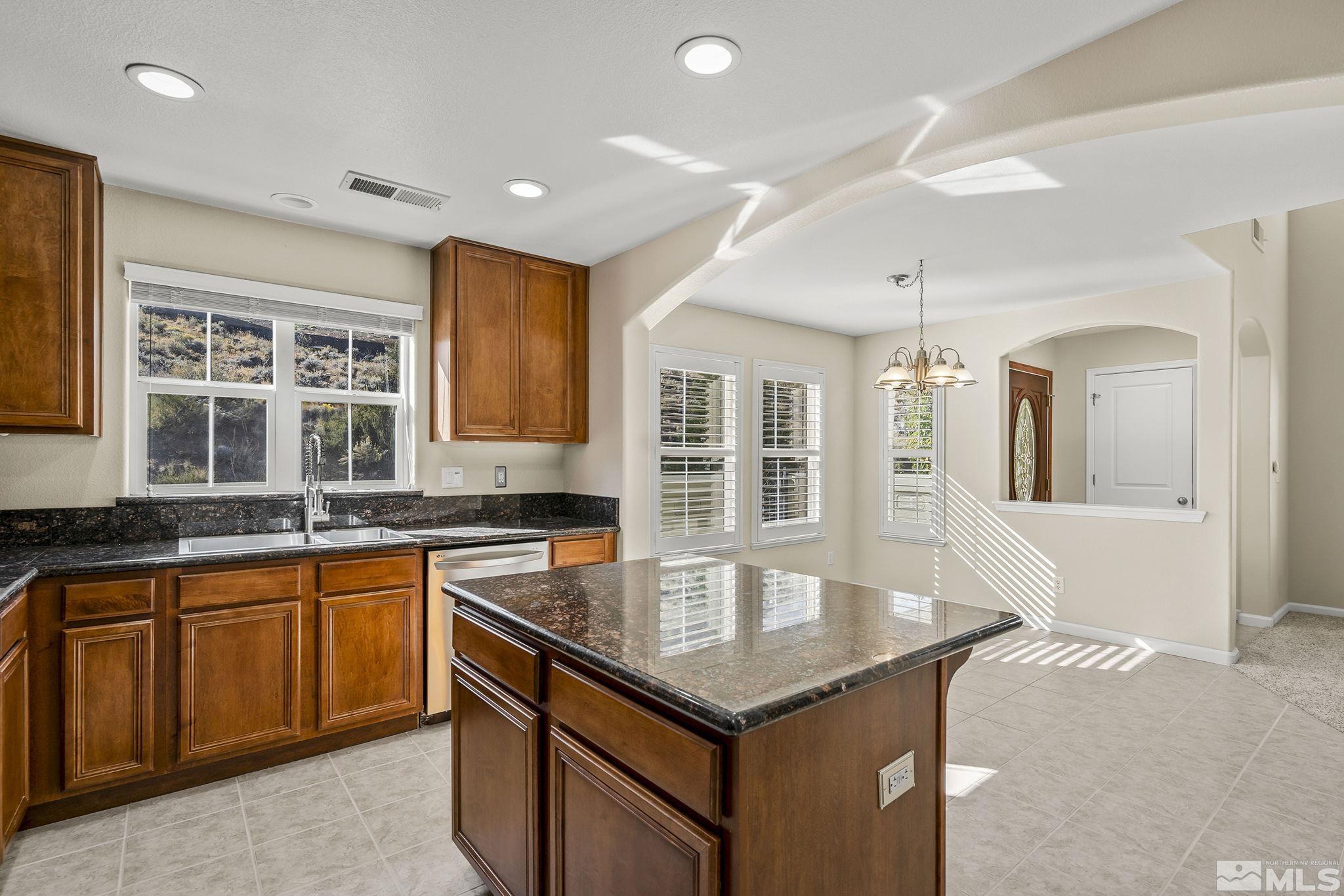 7688 Stone Bluff Way Reno, NV 89523 - Photo 10 of 26 a kitchen with granite countertop a sink and cabinets