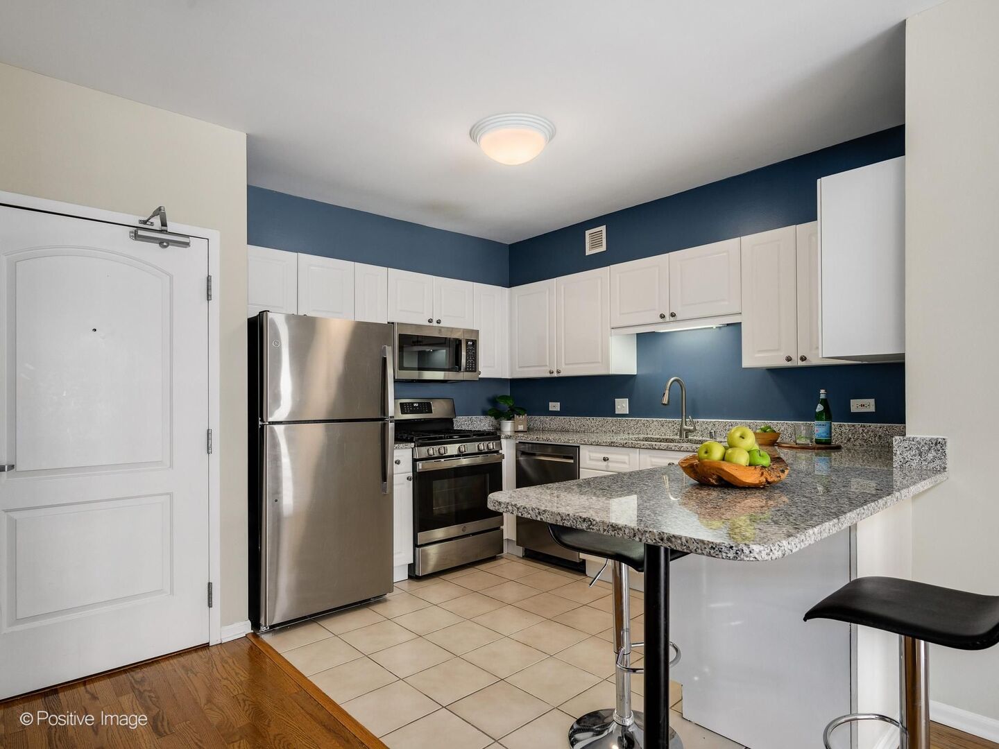21 West Chestnut Street, Unit 901 Chicago, IL 60610 - Photo 11 of 29 a kitchen with stainless steel appliances a refrigerator a stove a sink and a counter space