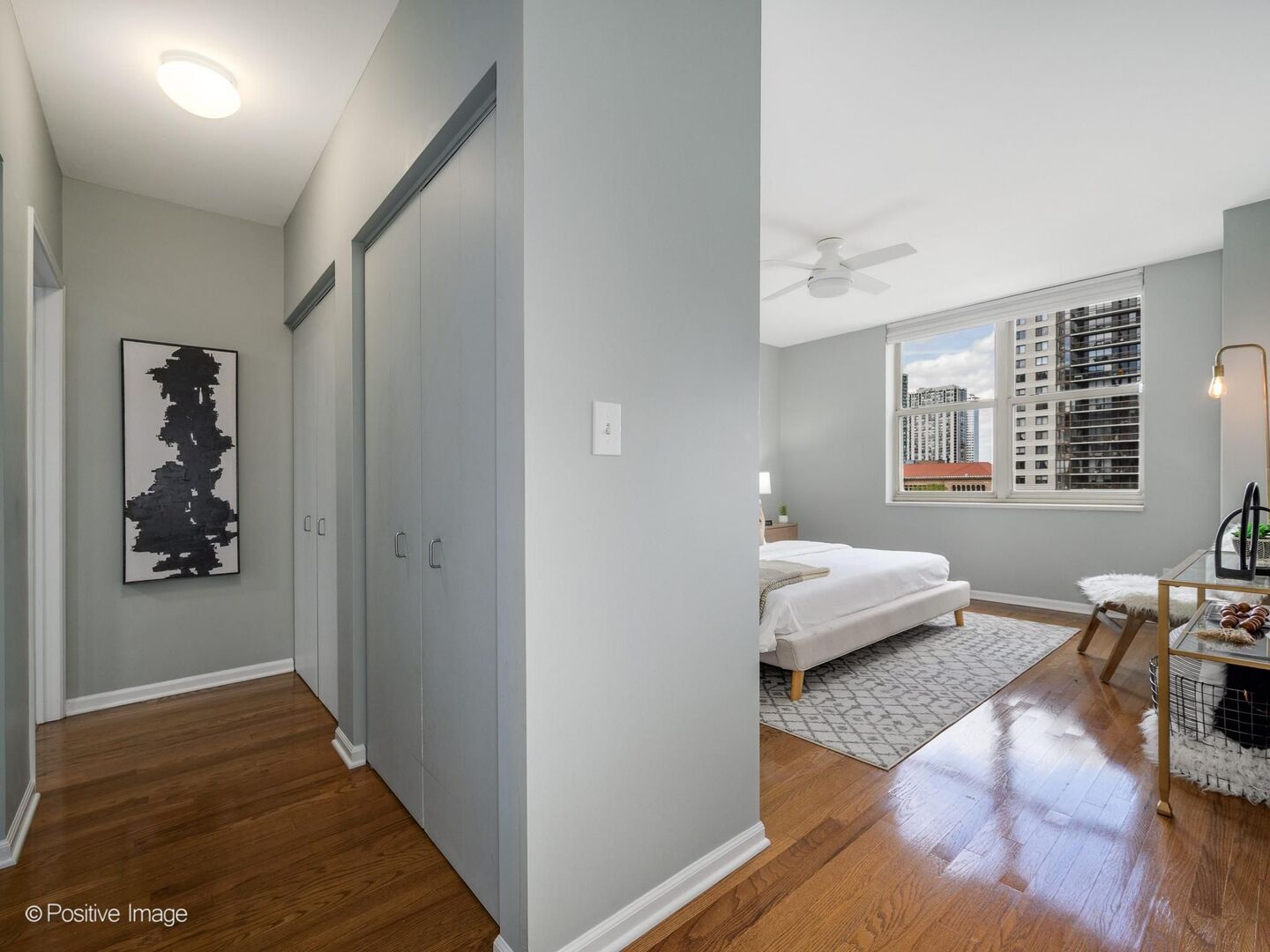 21 West Chestnut Street, Unit 901 Chicago, IL 60610 - Photo 14 of 29 a bedroom with wooden floor and a window