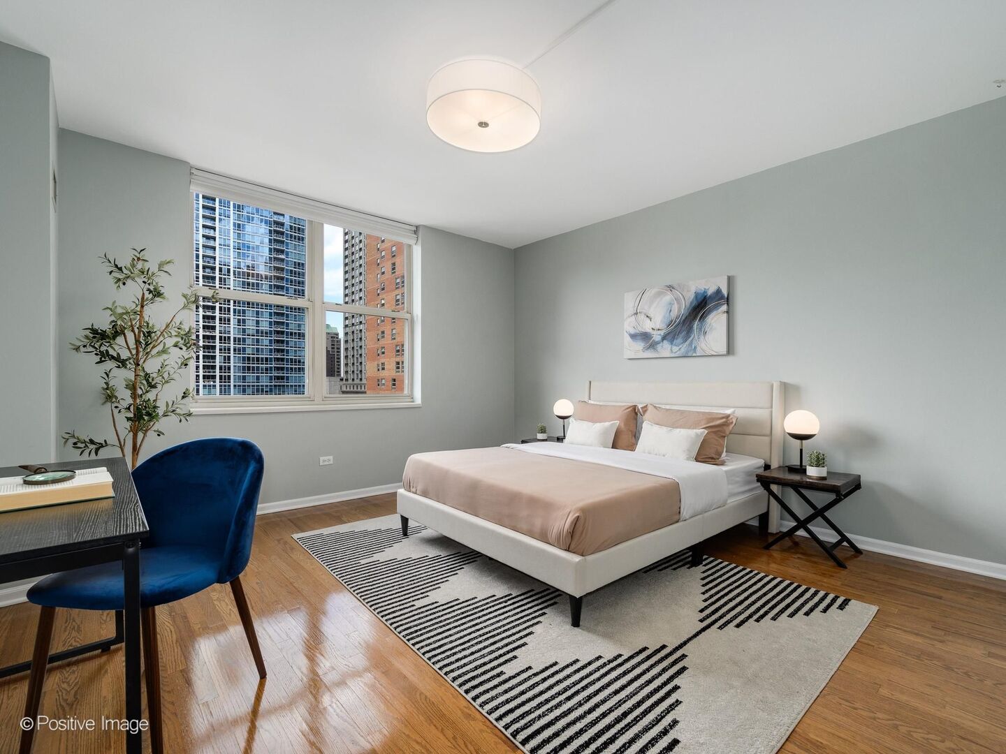 21 West Chestnut Street, Unit 901 Chicago, IL 60610 - Photo 18 of 29 a bedroom with a bed and wooden floor