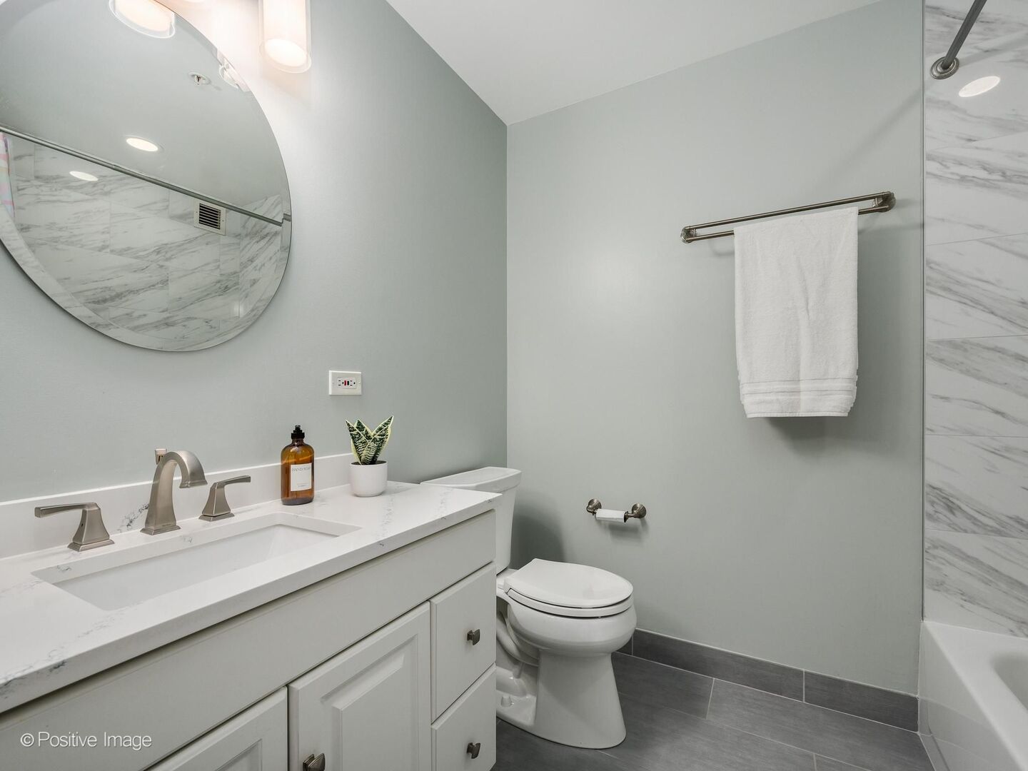 21 West Chestnut Street, Unit 901 Chicago, IL 60610 - Photo 20 of 29 a bathroom with a toilet sink and mirror