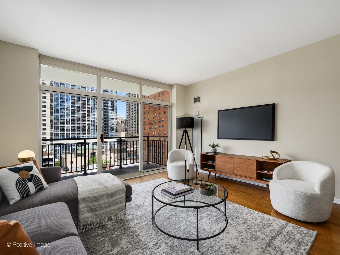 21 West Chestnut Street, Unit 901 Chicago, IL 60610 - Photo 8 of 29 a living room with furniture a flat screen tv and a large window
