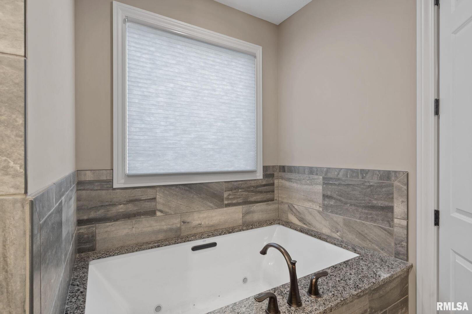 1422 Racine Court Davenport, IA 52804 - Photo 23 of 53 a bathroom with a granite countertop sink and bathtub