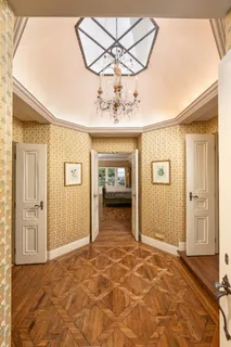 a bed sitting in a spacious bedroom next to a fireplace