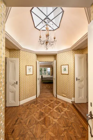 a bed sitting in a spacious bedroom next to a fireplace