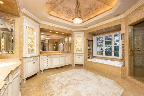 a bedroom with a large bed and wooden floor