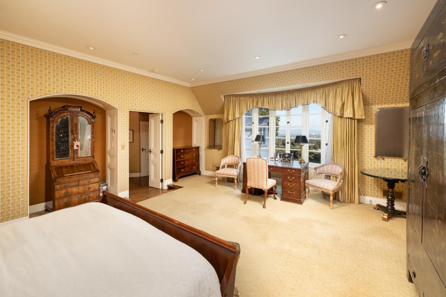 3085 Ralston Avenue Hillsborough, CA 94010 - Photo 16 of 29 a bedroom with a large bed and wooden floor