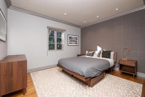 a bathroom with a granite countertop sink a toilet a mirror and shower