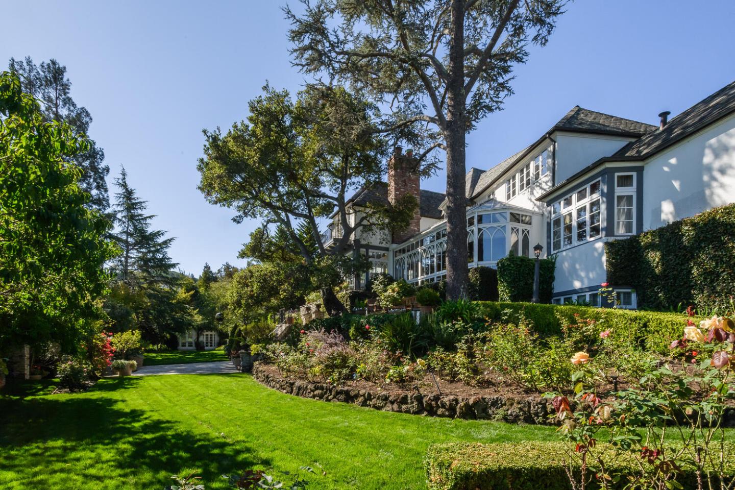 3085 Ralston Avenue Hillsborough, CA 94010 - Photo 25 of 29 a view of a white house next to a yard with a tree