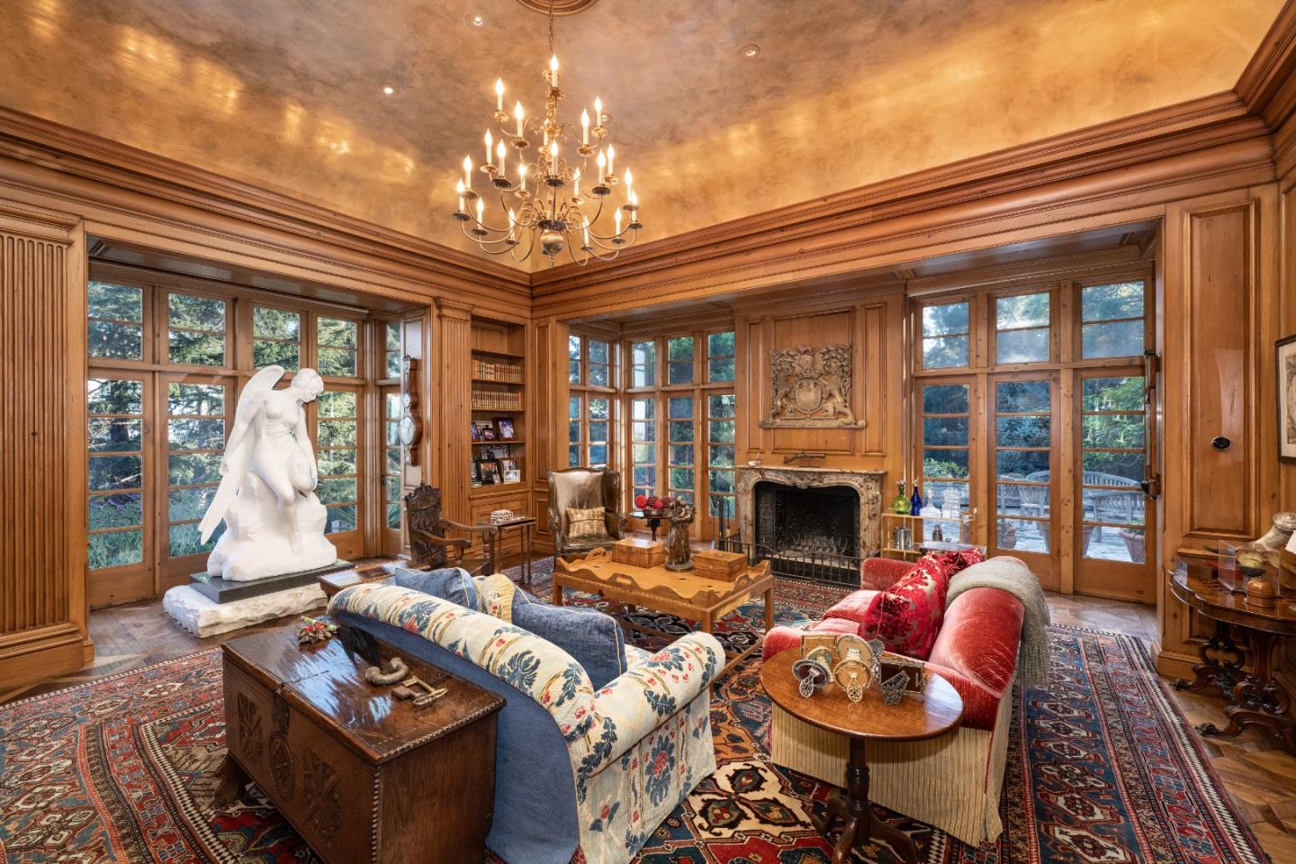 3085 Ralston Avenue Hillsborough, CA 94010 - Photo 4 of 29 a living room with furniture a chandelier and a fireplace
