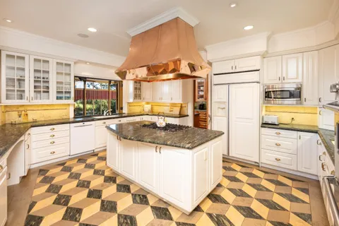 a kitchen with stainless steel appliances granite countertop a sink and a stove