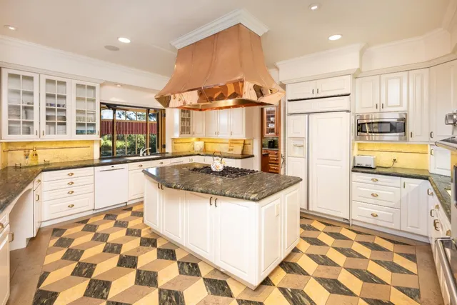 a kitchen with stainless steel appliances granite countertop a sink and a stove