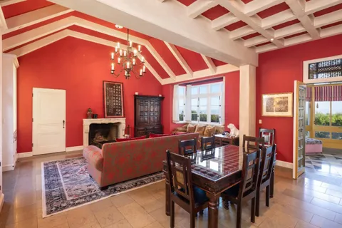 a dining room with furniture a fireplace and wooden floor