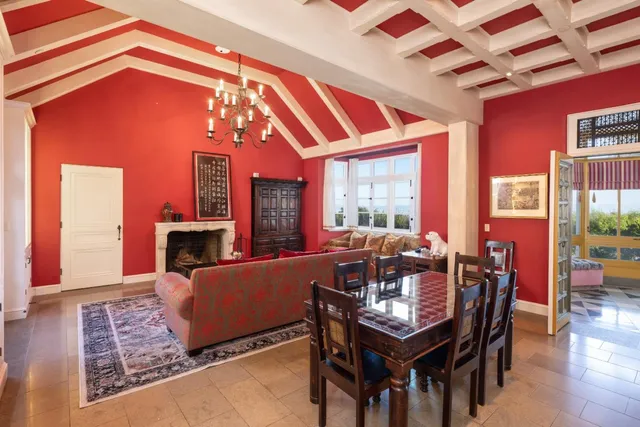 a dining room with furniture a fireplace and wooden floor