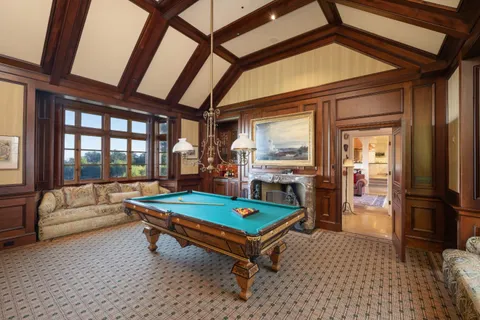 a living room with furniture a flat screen tv and next to a large window