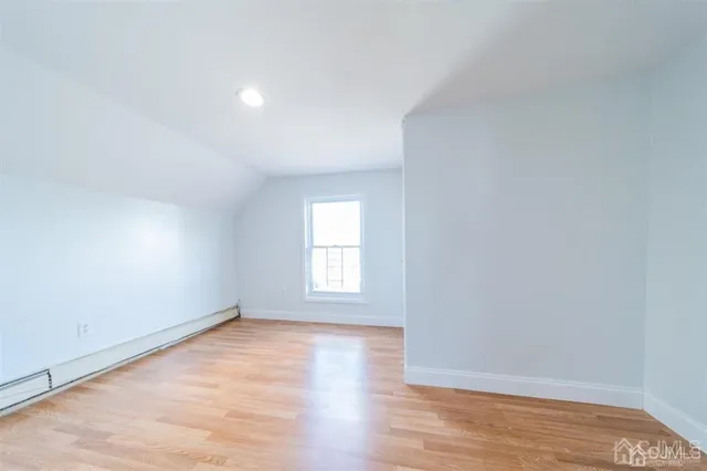 a view of hallway with wooden floor