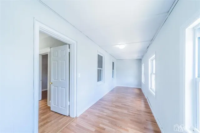 a kitchen with stainless steel appliances a refrigerator a stove a sink and a window