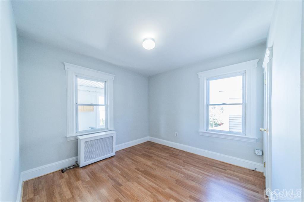 125 Lowell Street, Unit 2 Carteret, NJ 07008 - Photo 8 of 12 an empty room with windows