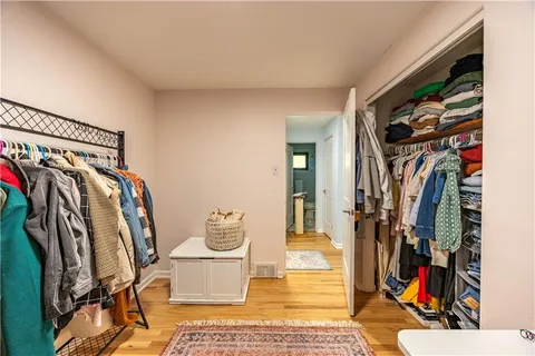 a view of walk in closet with clothes and shoes