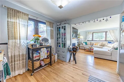 a living room with furniture and a book shelf